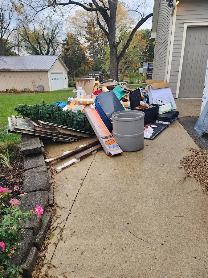 Dumpster being loaded with debris for Commercial Dumpster Rental in Sherrelwood